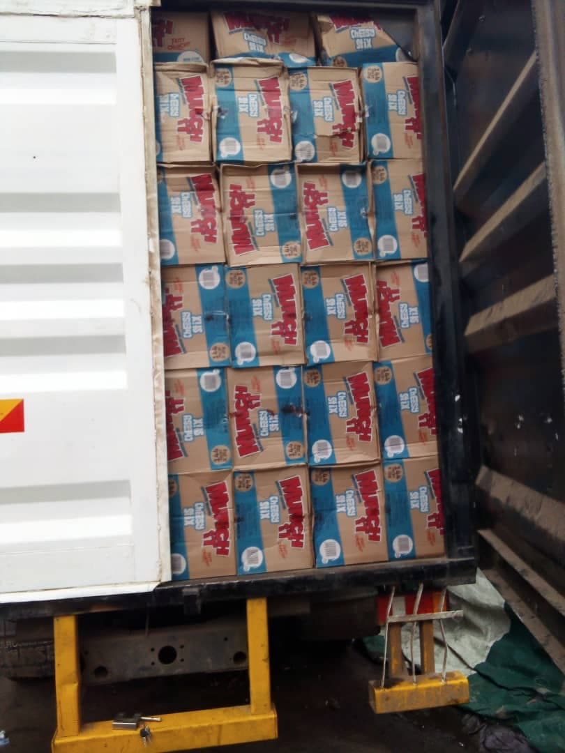 Cartons of packaged consumer goods loaded into an export container